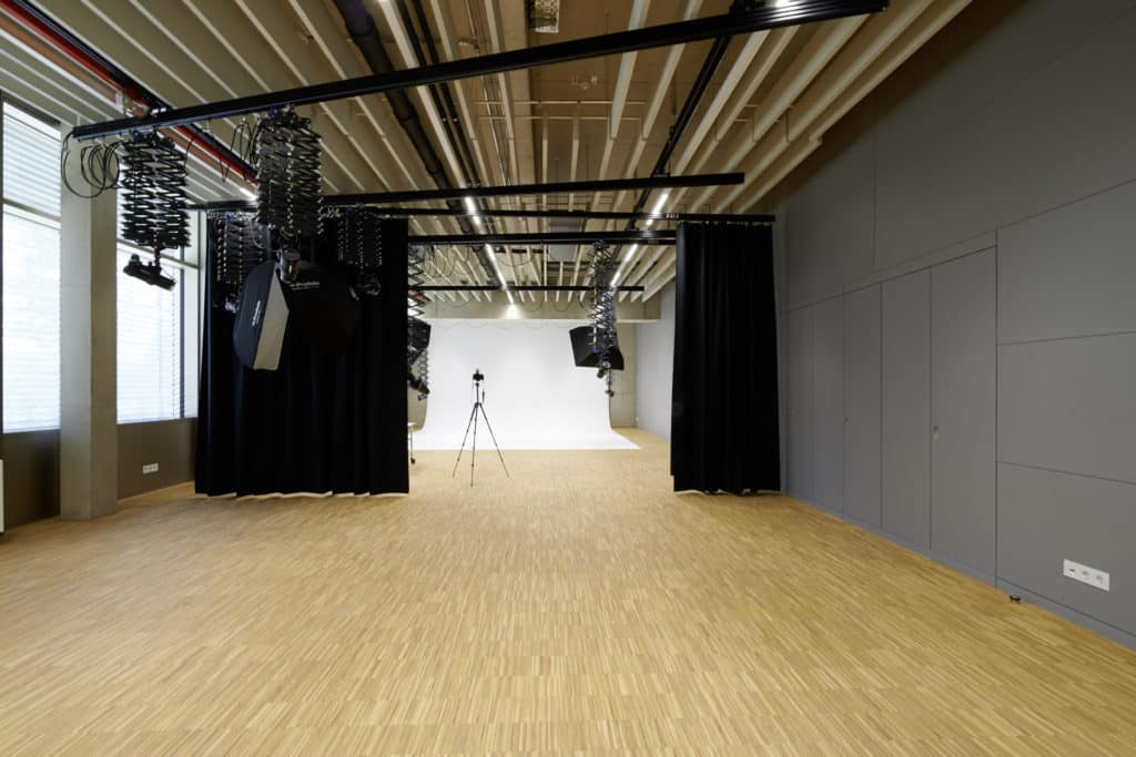 Foto-Studio mit Un sol en parquet. En arrière-plan, un rideau noir